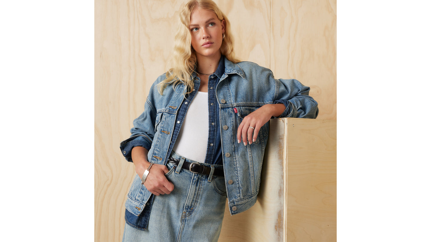 Woman in layered Levi's denim jacket styled with skirt