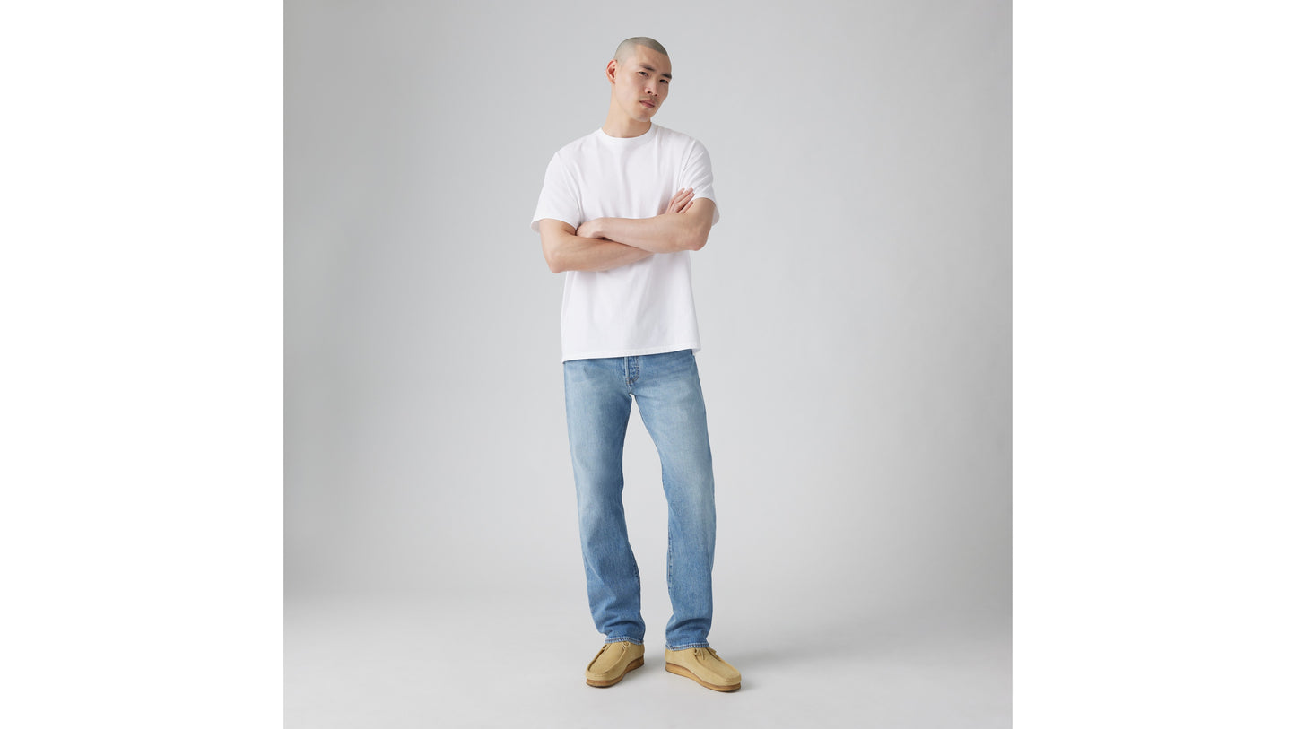 Levi’s light-wash jeans paired with white tee and tan shoes
