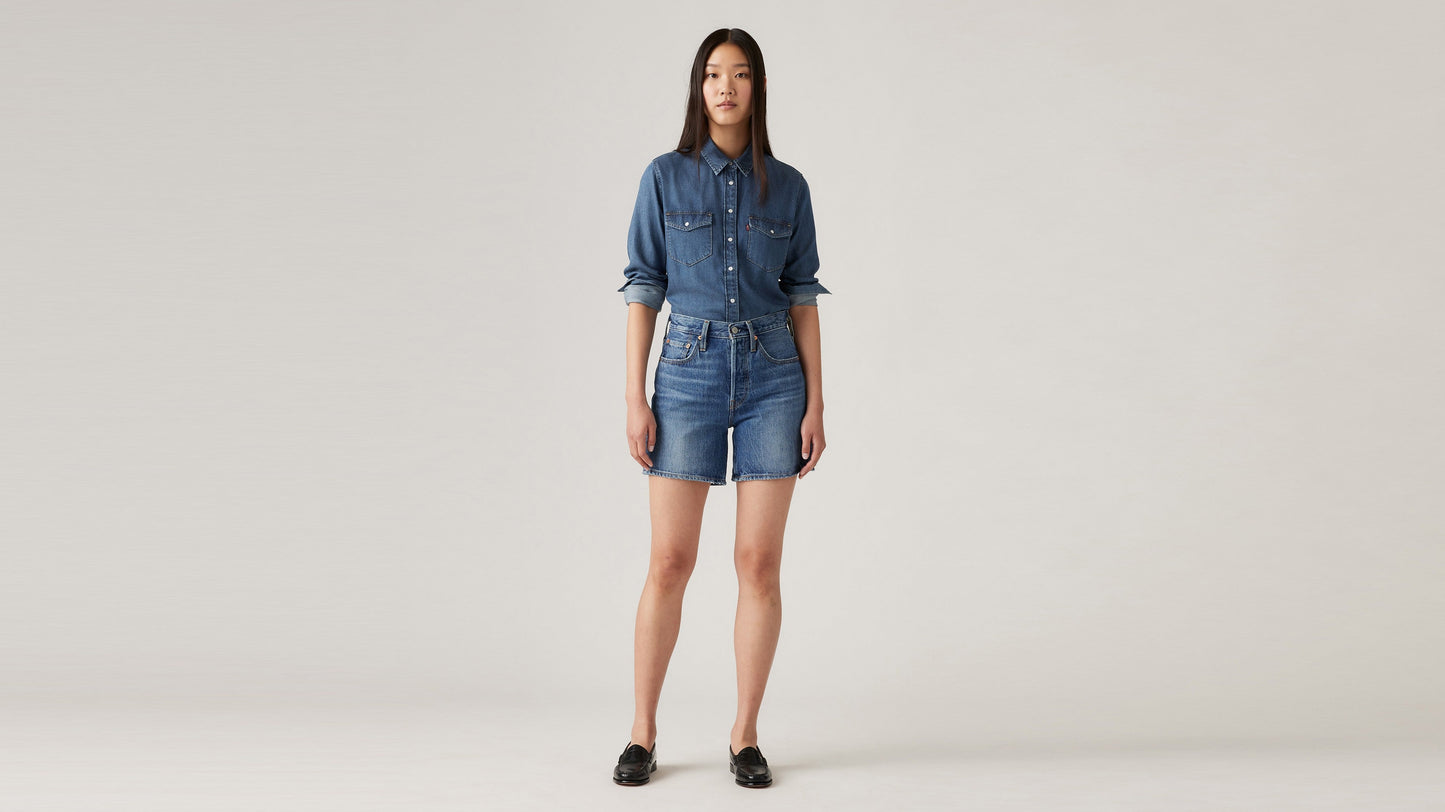 Woman in Levi's womens mid thigh shorts and long sleeves denim