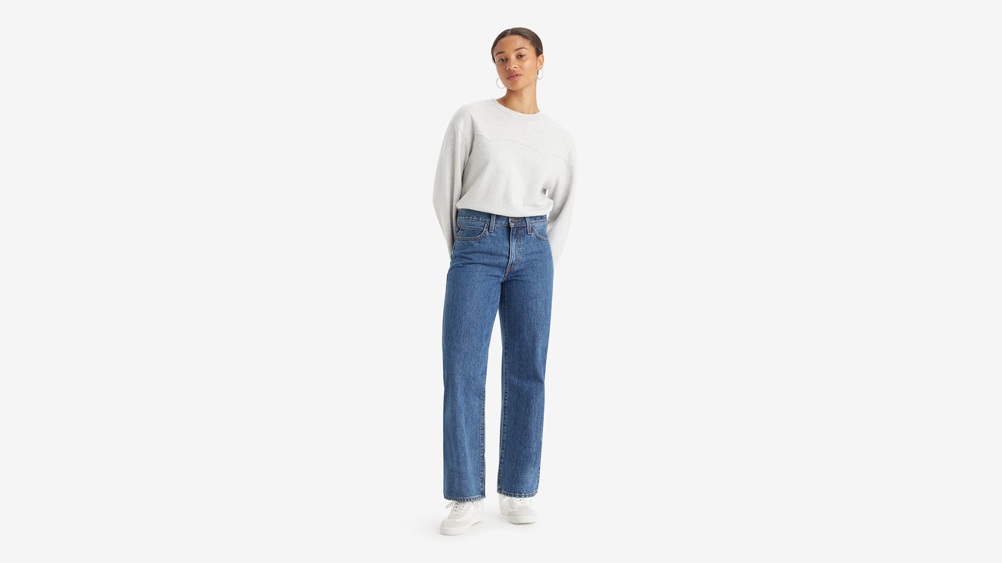 Woman in Levi's 94 Baggy jeans and light sweater, front view