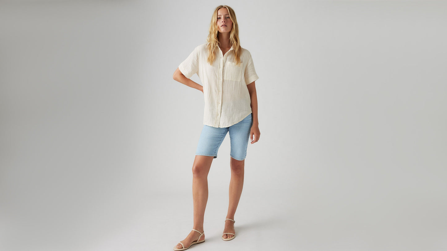 Front view of womens faded blue bermuda shorts and button shirt