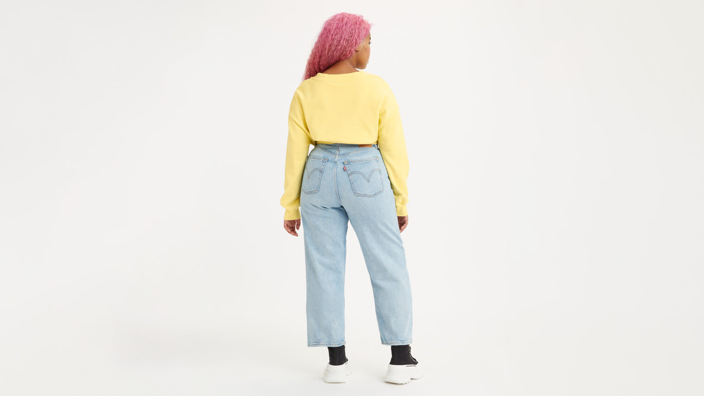 Woman in light-wash Levi's jeans back view