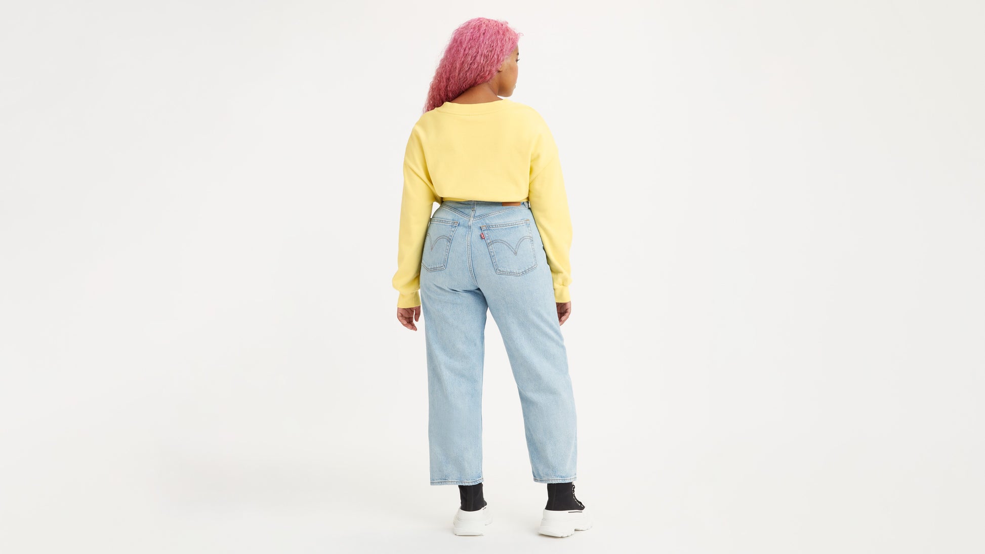 Woman in light-wash Levi's jeans back view