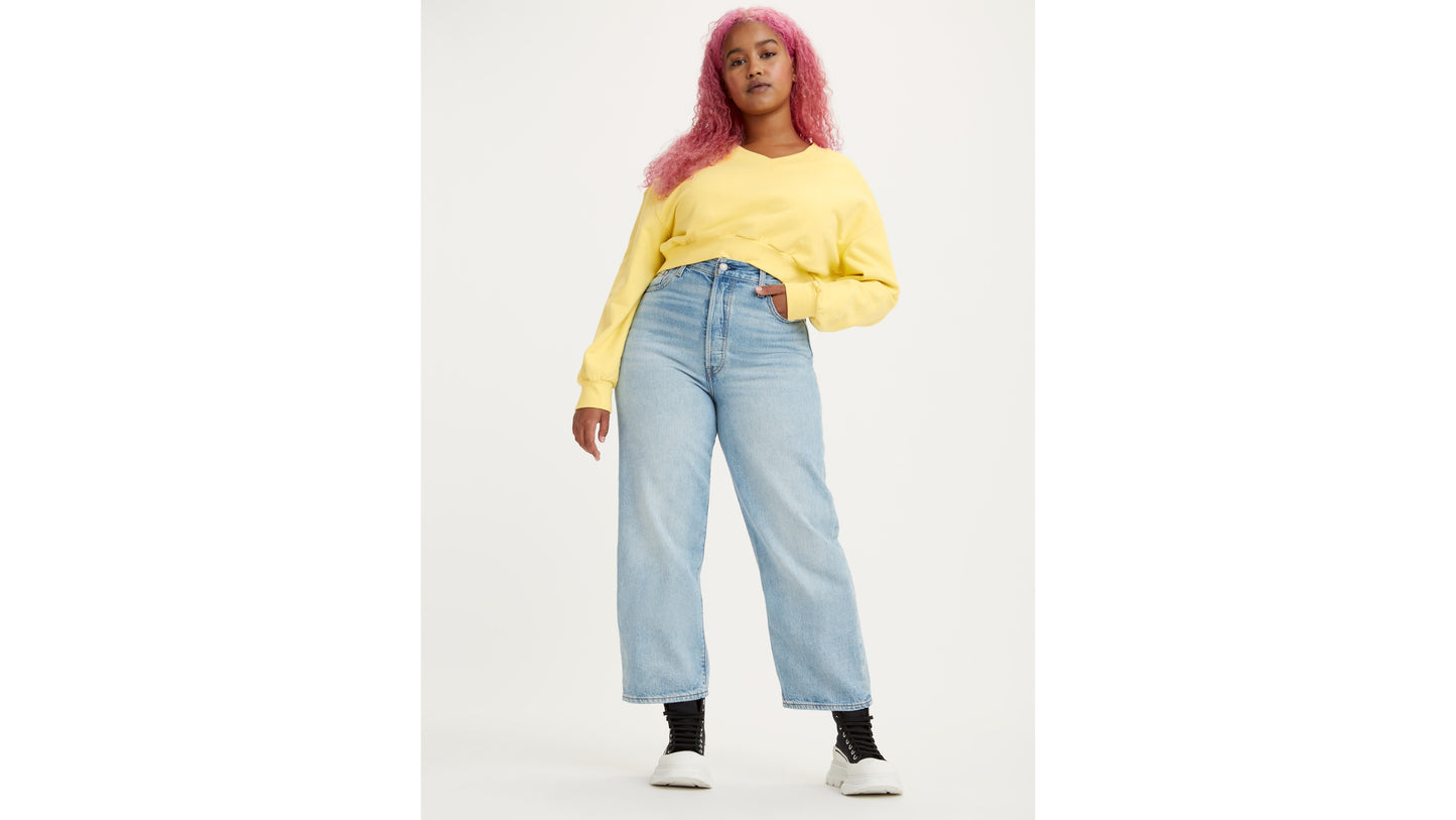 Woman in high-rise Levi's jeans and yellow sweatshirt