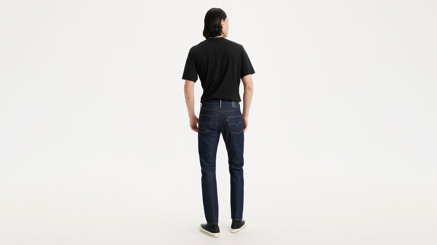 Model wearing black shirt and Levi's jeans, back view