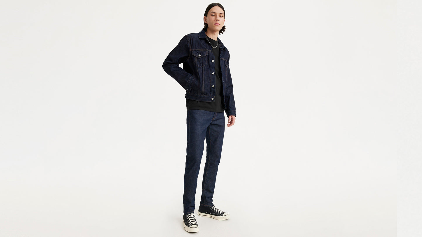 Model wearing jacket and Levi's jeans, angled front view