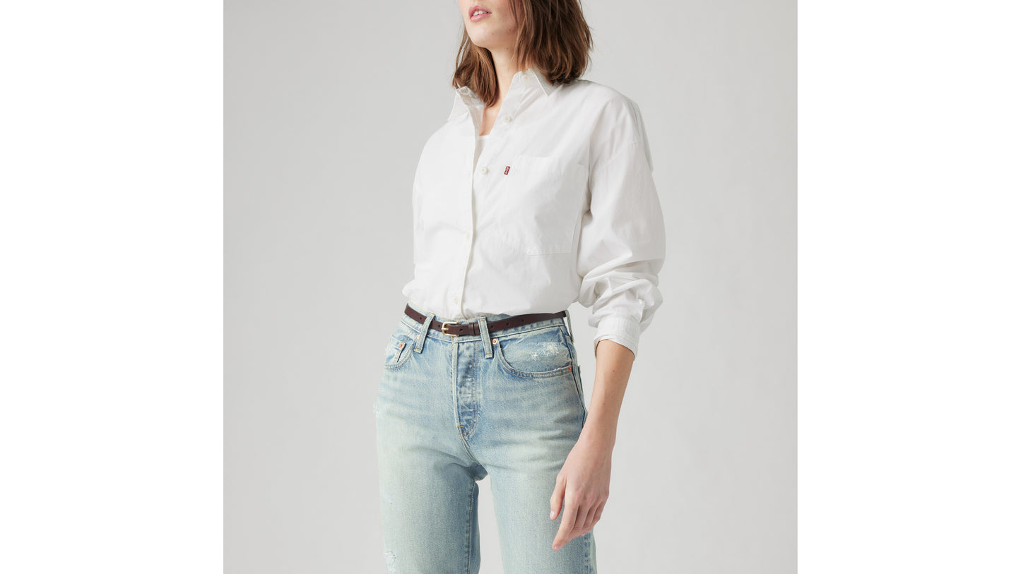 Levi's white button-up shirt with light-wash distressed jeans