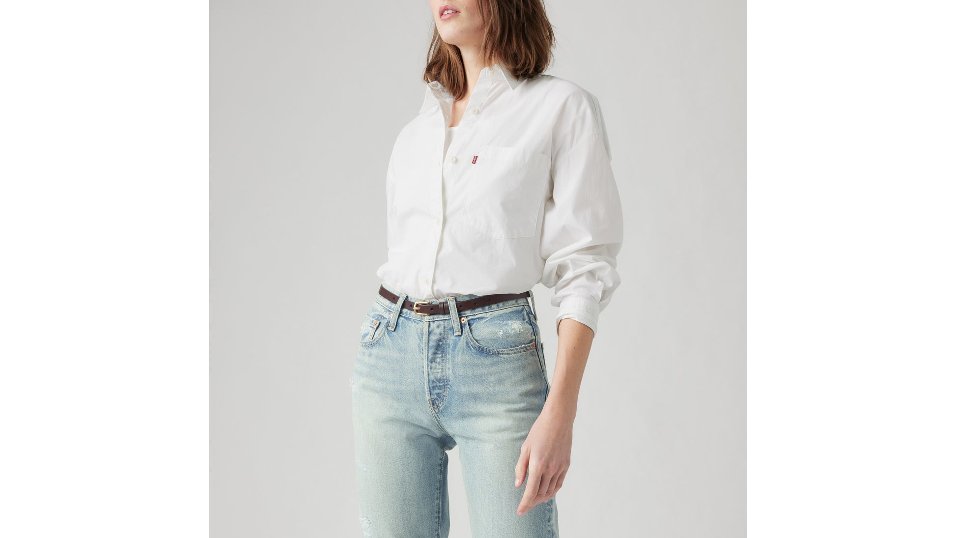 Levi's white button-up shirt with light-wash distressed jeans