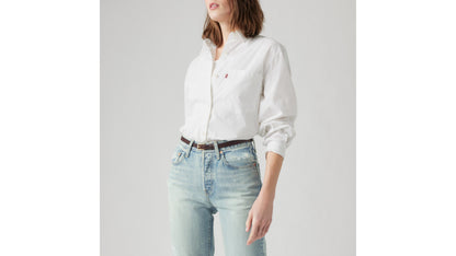 Levi's white button-up shirt with light-wash distressed jeans