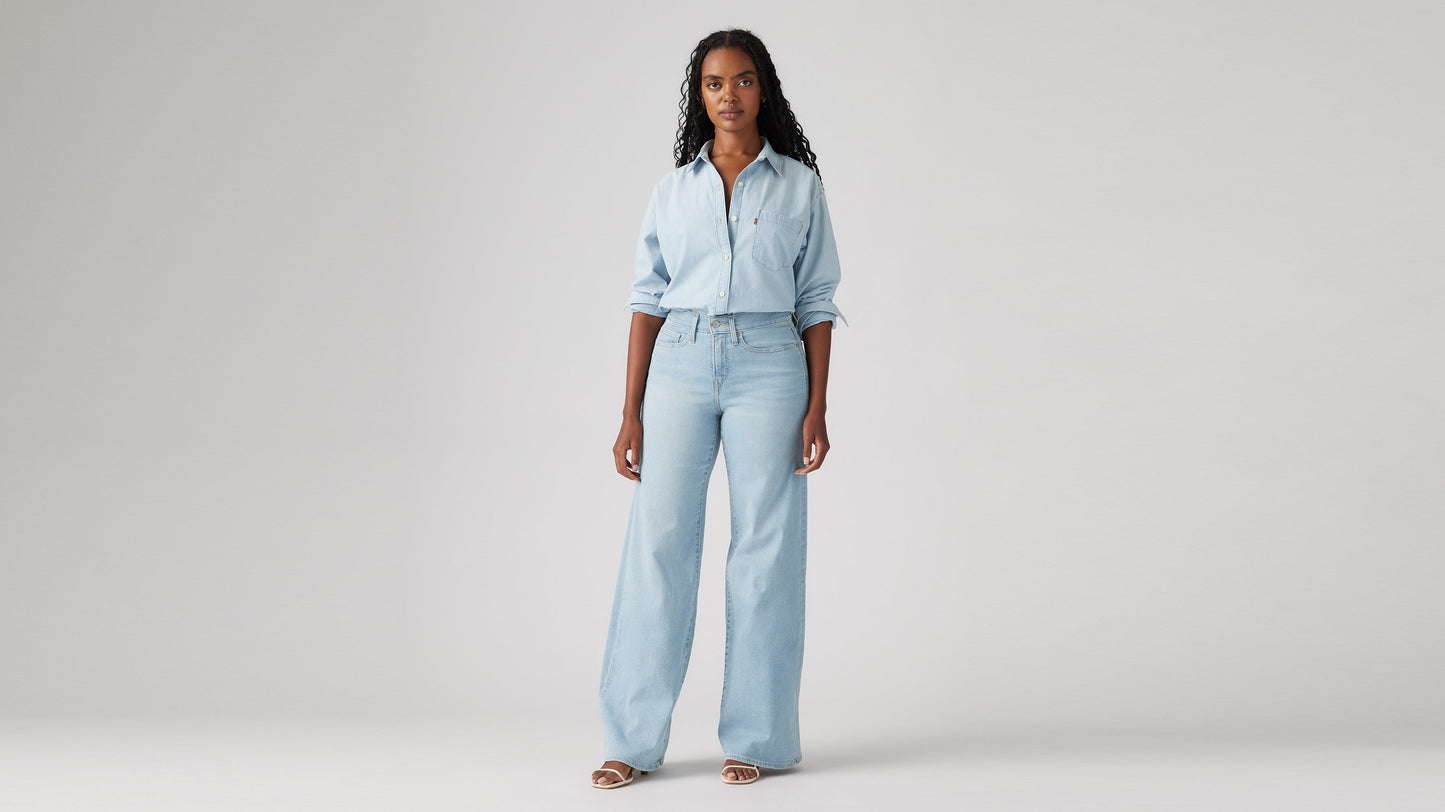 Model wearing Levi's women's jeans, washed, angled front view