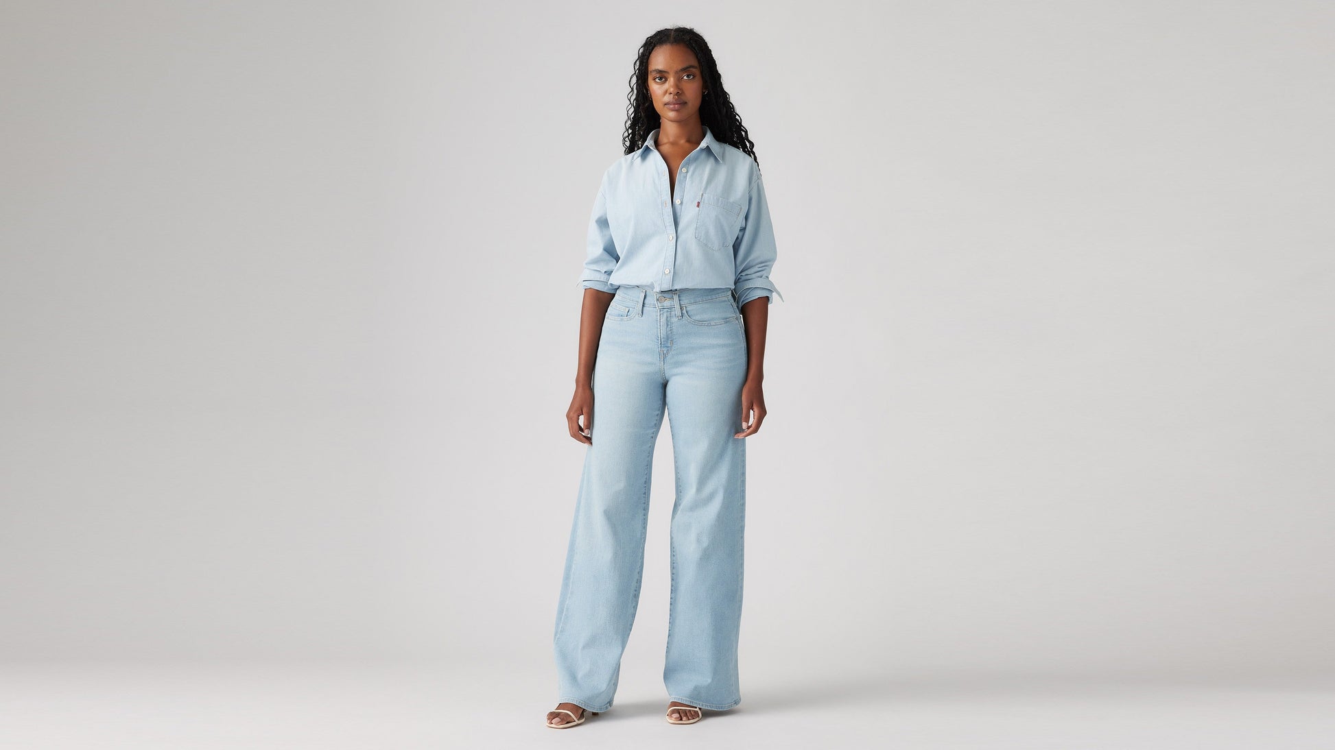 Model wearing Levi's women's jeans, washed, angled front view