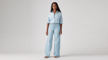Model wearing Levi's women's jeans, washed, angled front view