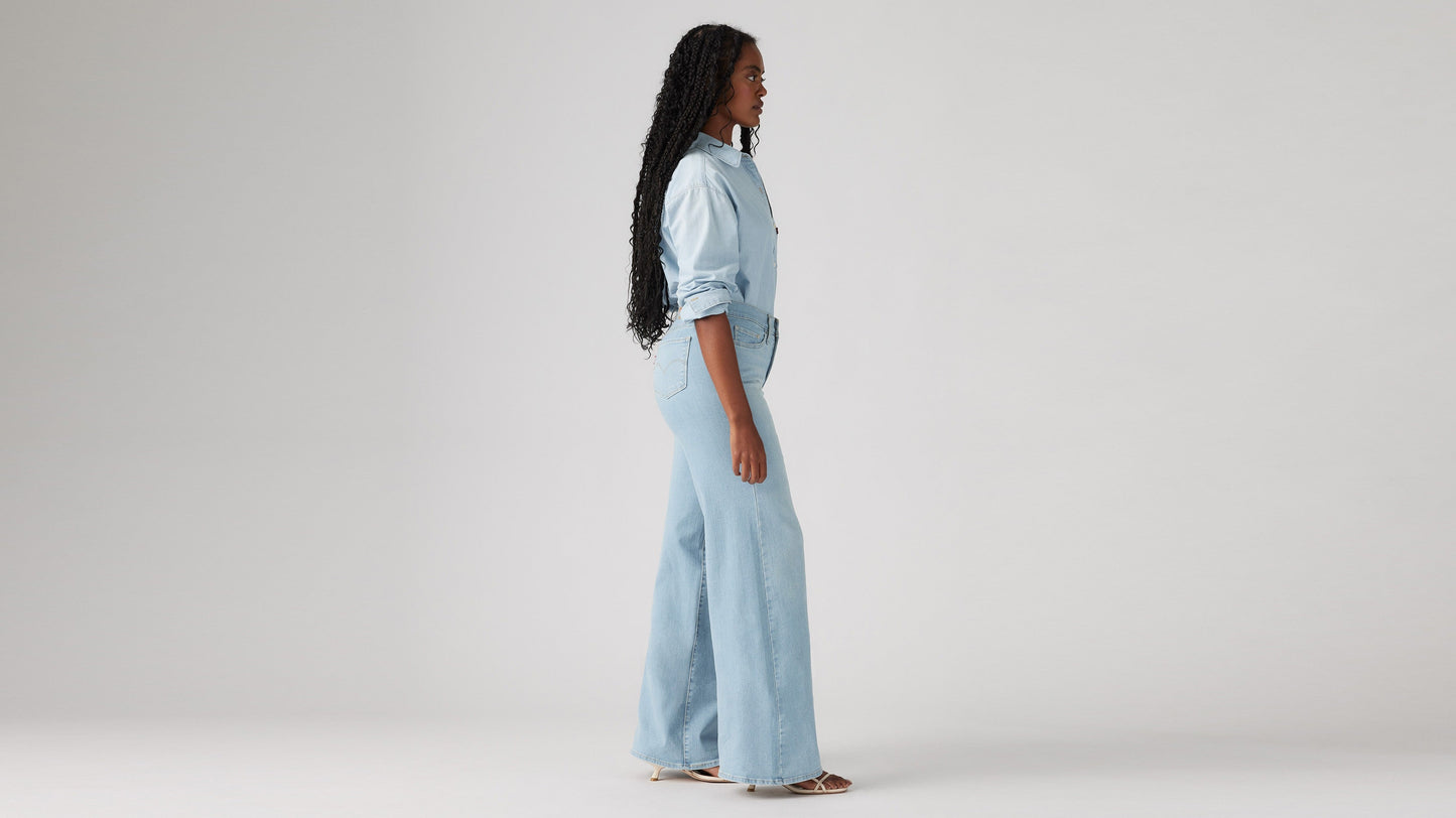 Model wearing Levi's women's jeans, washed, side view