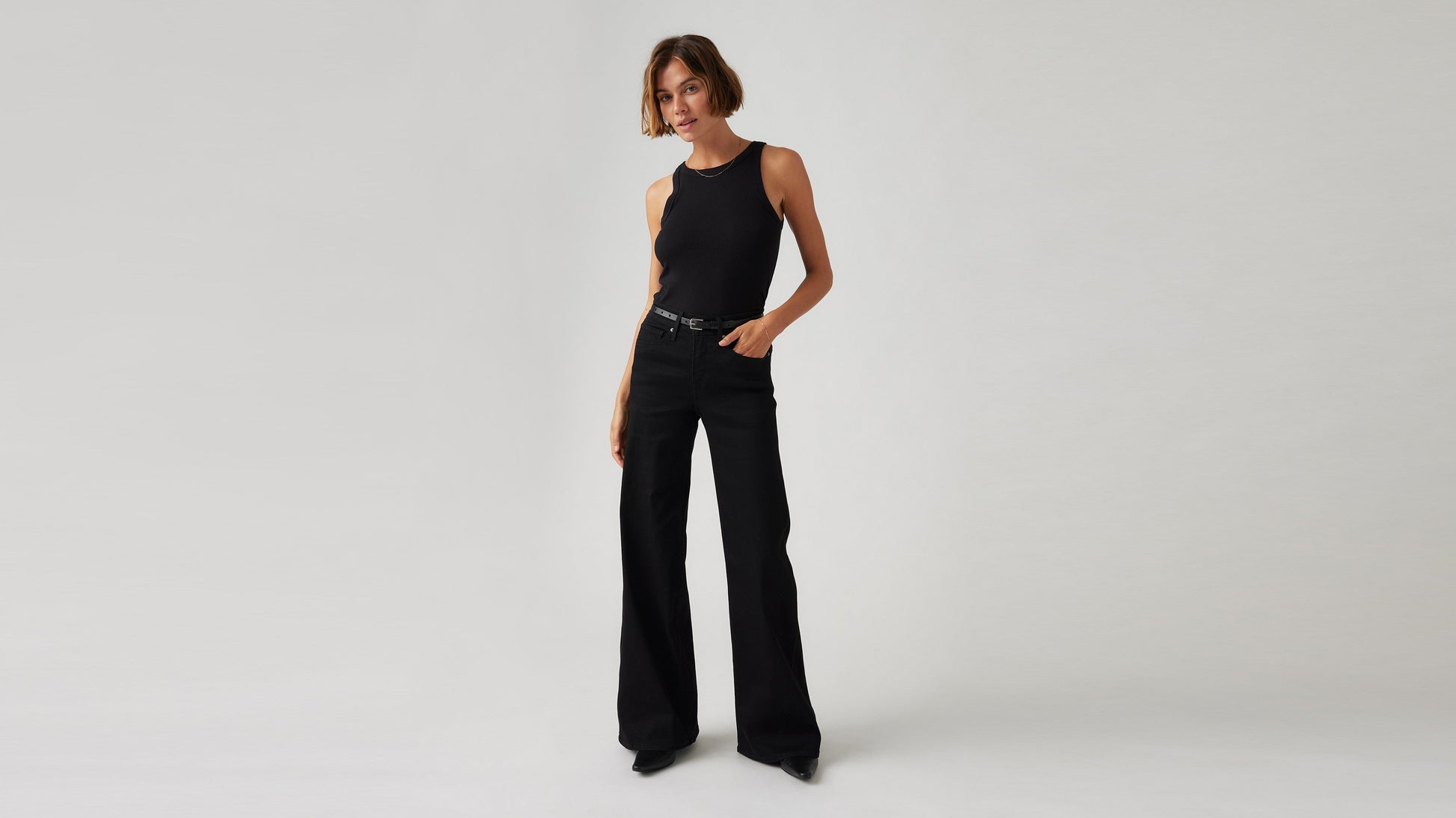 Model wearing Levi's women's black jeans, front view