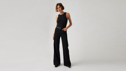 Model wearing Levi's women's black jeans, front view