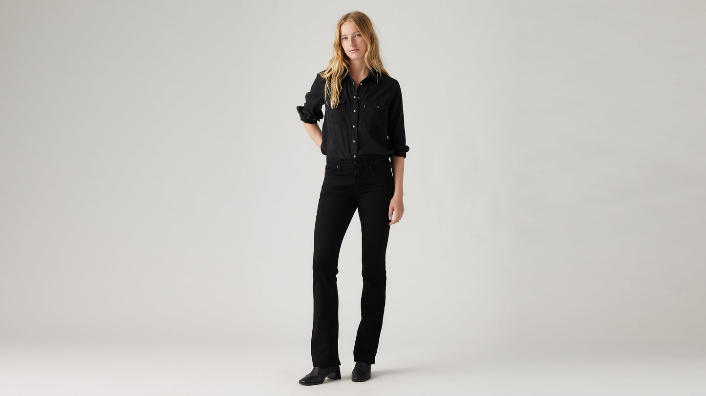 Woman in Levi's shirt and bootcut jeans in black