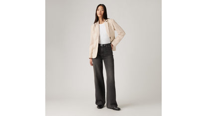 Woman in Levi's black wide-leg jeans and beige blazer