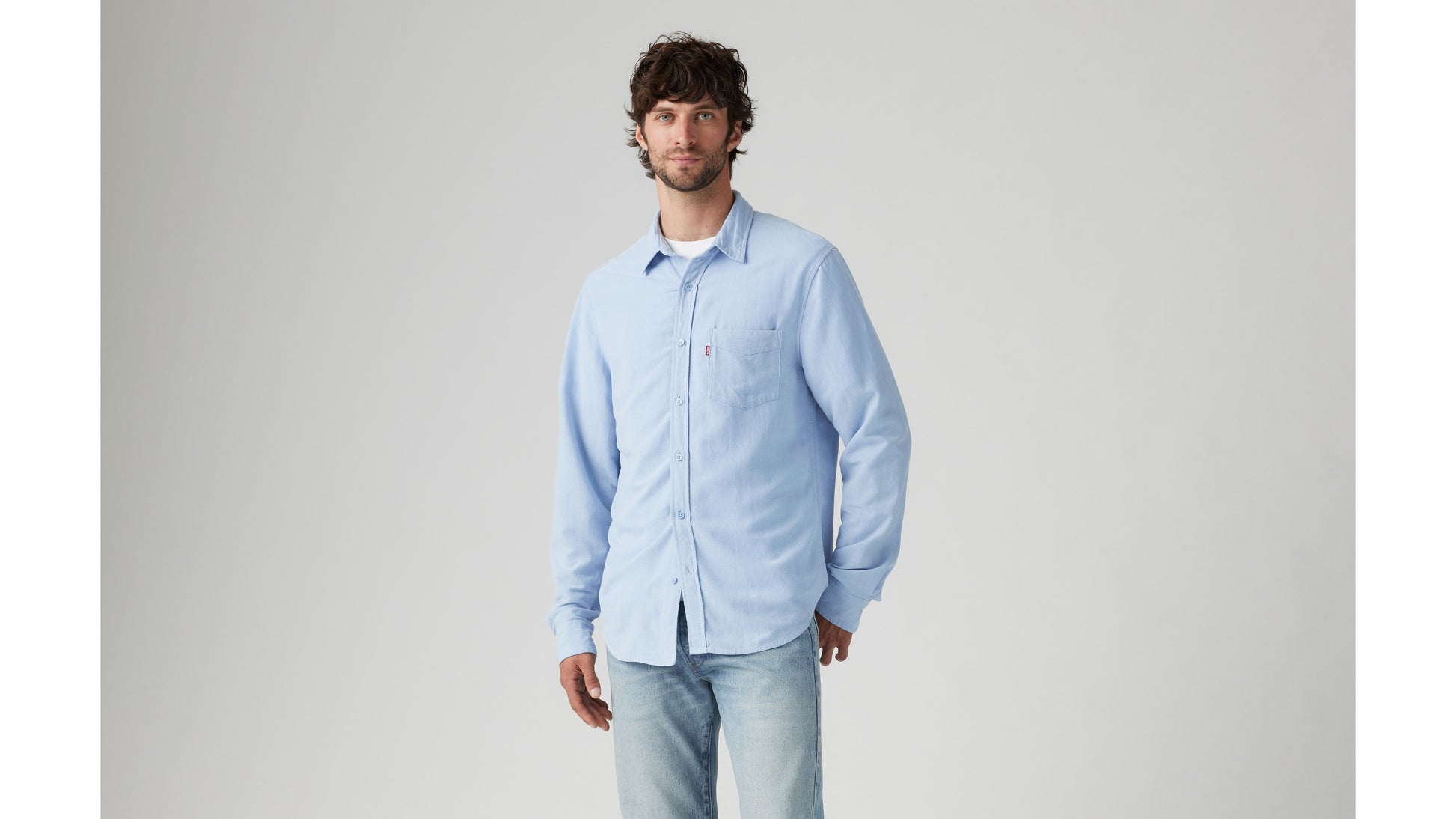 Model in Levi's light-blue shirt and denim jeans
