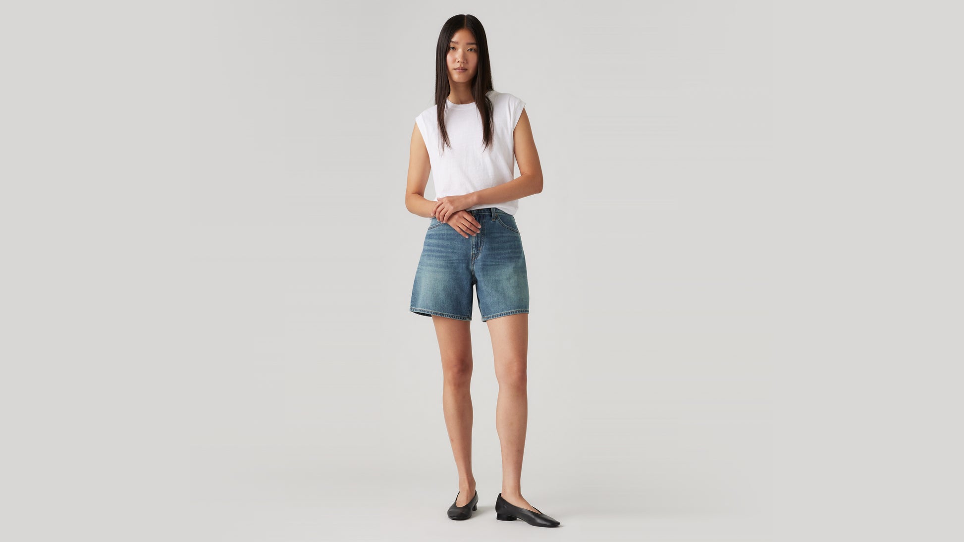 Levi's high-waisted women's denim shorts and white tank