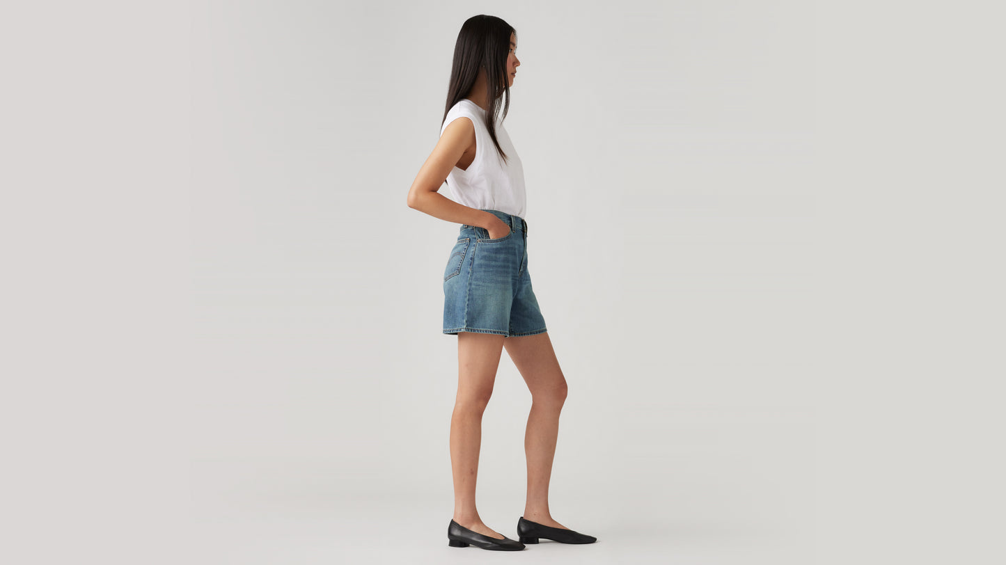 Woman in high-waisted Levi's denim shorts side view