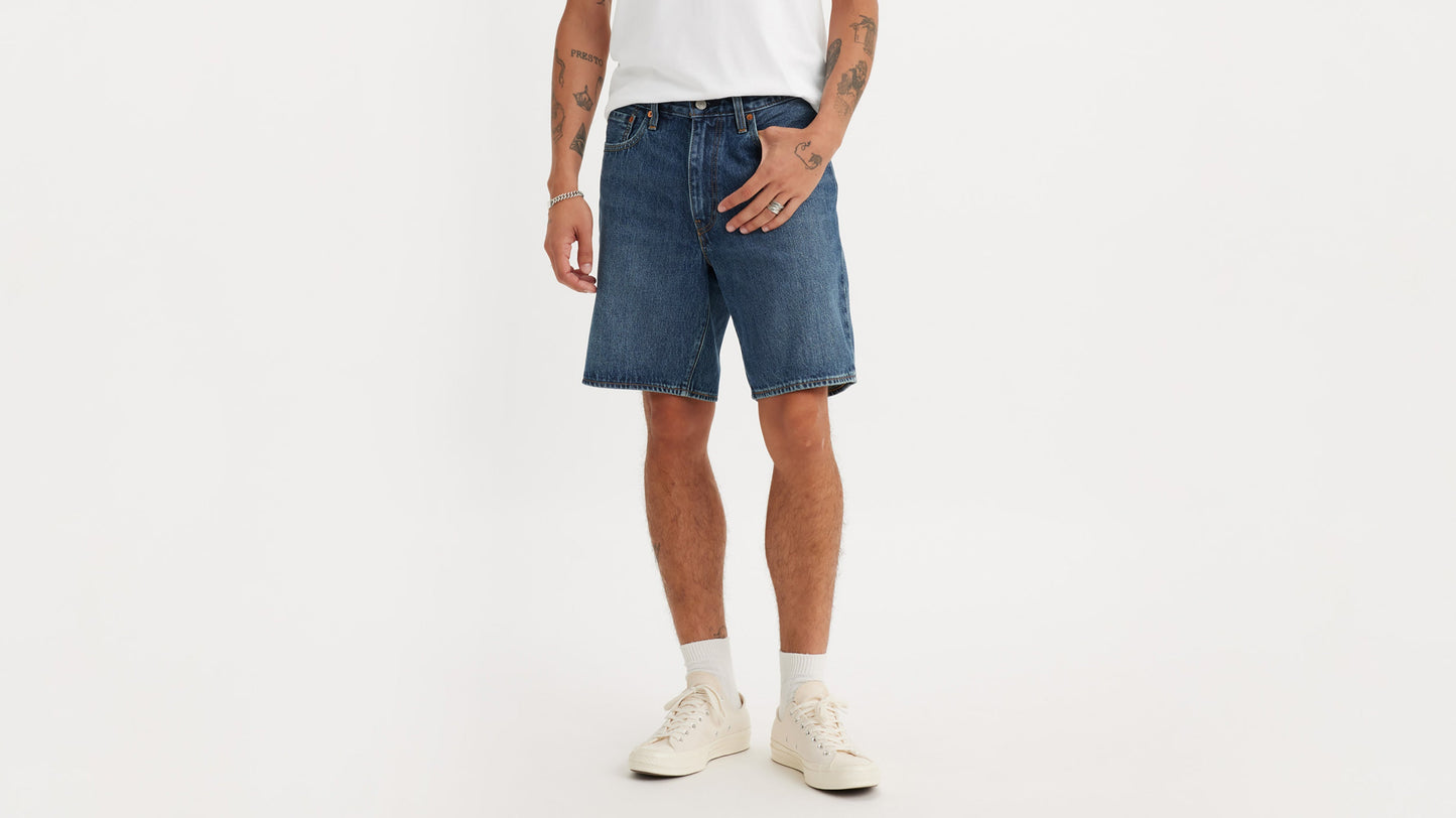 Cropped front view of man in Levi’s 468 Shorts in dark wash paired with sneakers