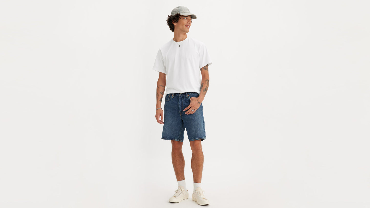 Front view of man in Levi's 468 Loose Shorts in dark wash blue, styled casually