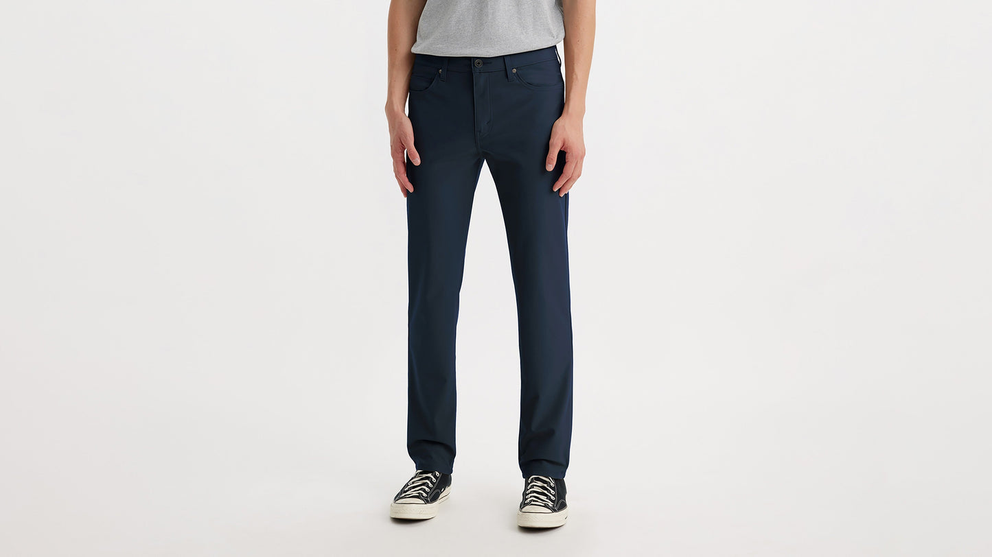 Cropped front view of Levi’s slim fit navy tech pants on model