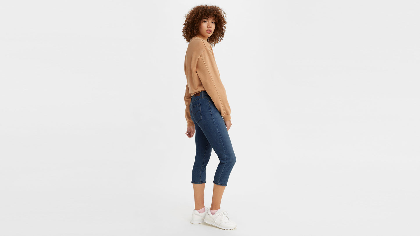 Woman in Levi’s cropped jeans and tan sweatshirt, side view