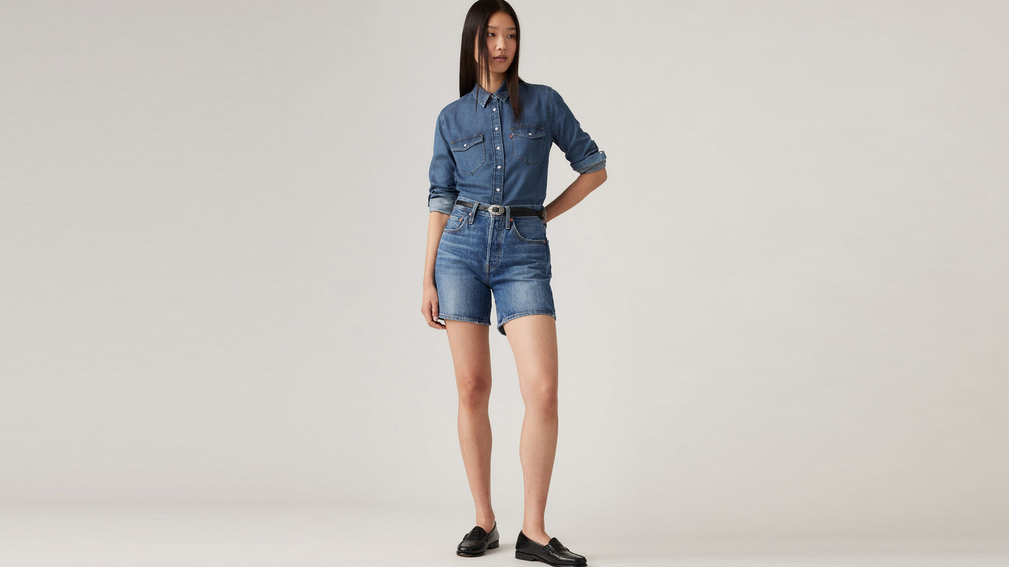 Woman in Levi's mid thigh shorts, long sleeves denim and loafers