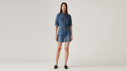 Woman in Levi's womens mid thigh shorts and long sleeves denim