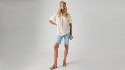 Front view of womens faded blue bermuda shorts and button shirt
