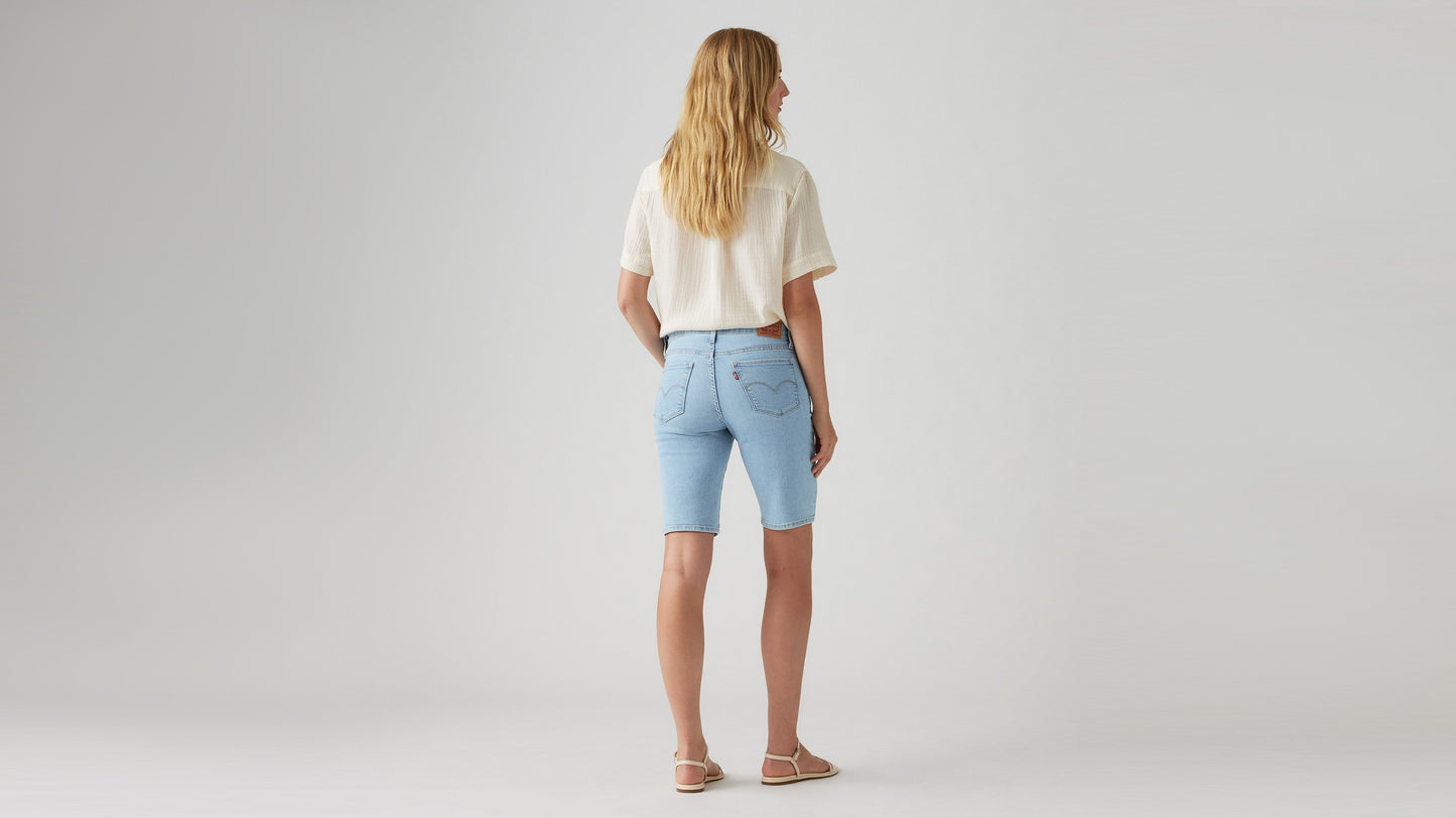 Woman in Levi's faded blue bermuda shorts back view