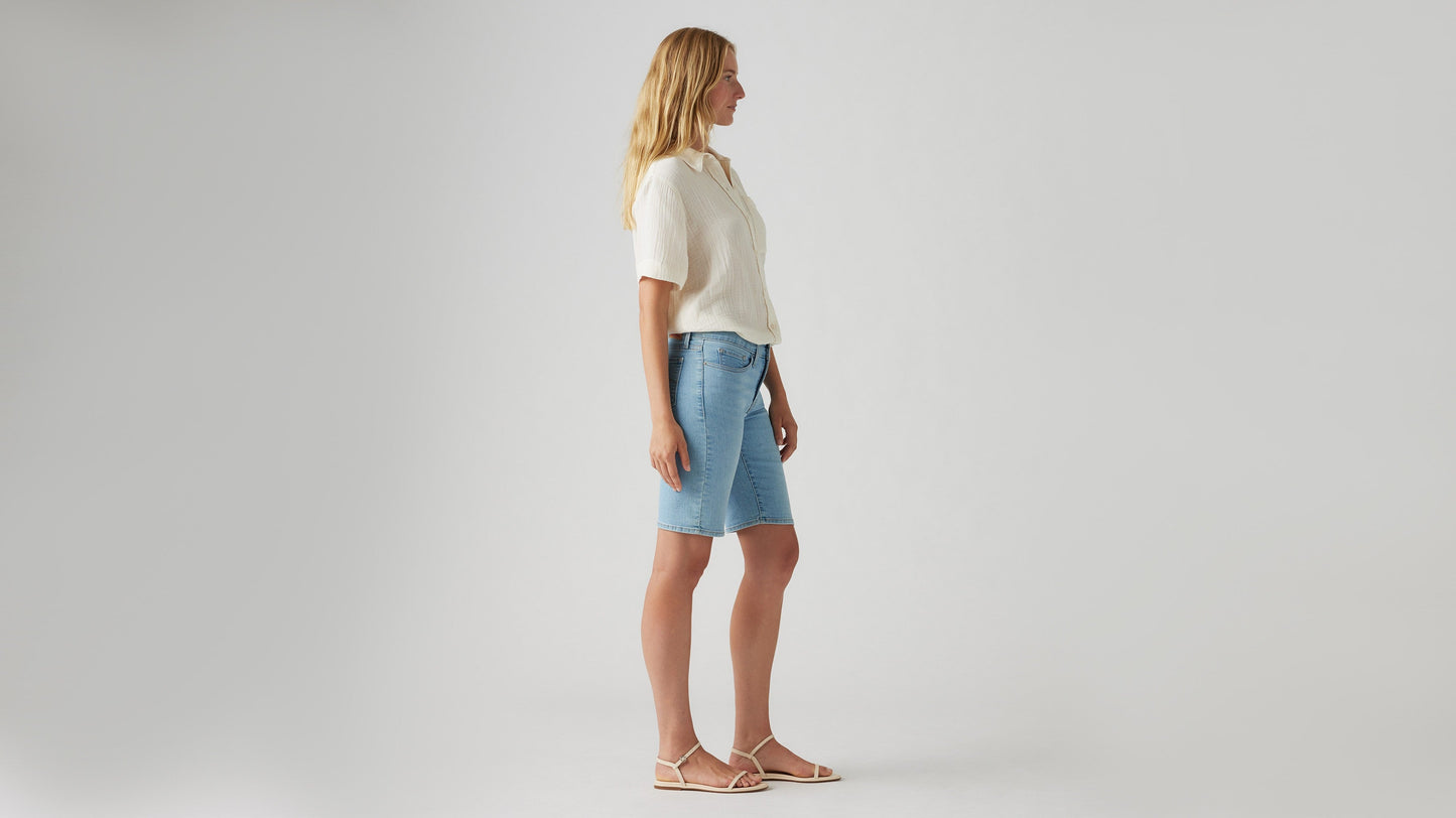 Side view of womens faded blue shaping bermuda shorts