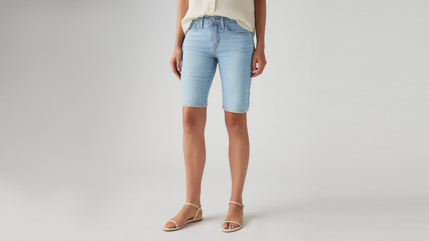 Woman in Levi's faded blue bermuda shorts close-up shot