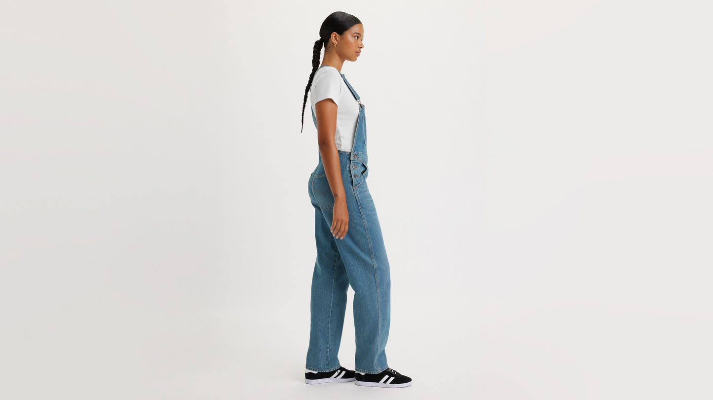 Side view of woman in Levi's womens vintage denim overalls