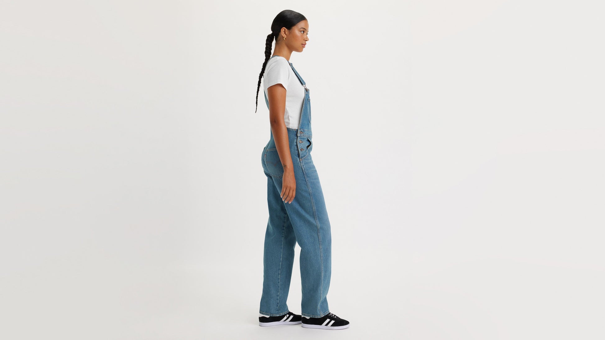 Side view of woman in Levi's womens vintage denim overalls